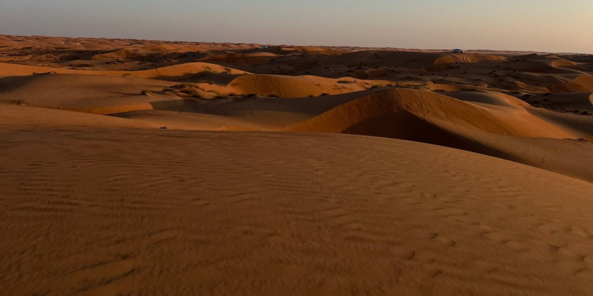 Desert landscape with sand dunes under a clear blue sky